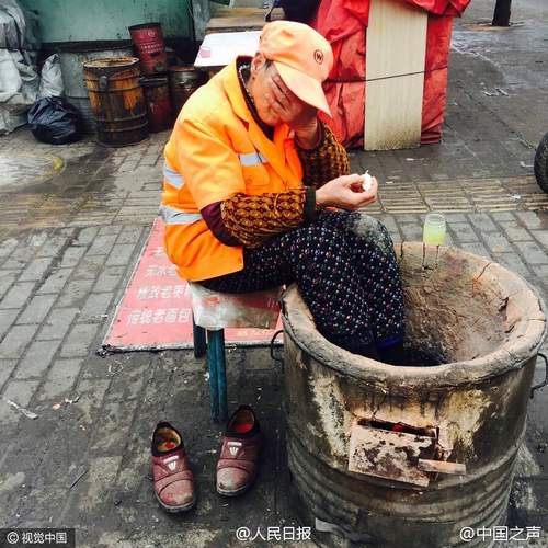 心酸！68岁保洁大妈将脚伸入火炉取暖