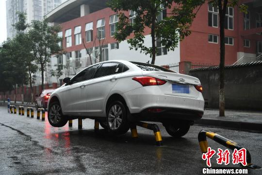 重庆街头一轿车“骑上”隔离栏