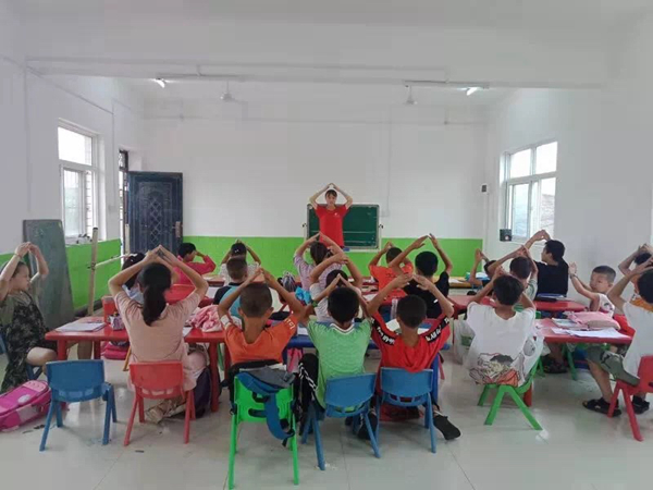 孩子们跟着队员们学习歌曲《国家》手势舞.jpg